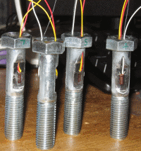 Strain gauged bolts for on-site testing.